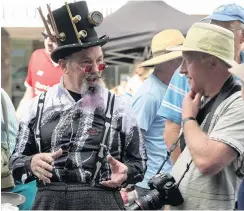  ??  ?? Crafty beggars . . . The Dunedin Steampunk Society stall, hosted by James Bryan, proved irresistib­le for English visitor Clive Harwood.