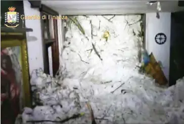  ?? GUARDIA DI FINANZA/AFP ?? A wall of snow engulfs the inside of the Hotel Rigopiano, near the village of Farindola, on the eastern lower slopes of the Gran Sasso mountain.