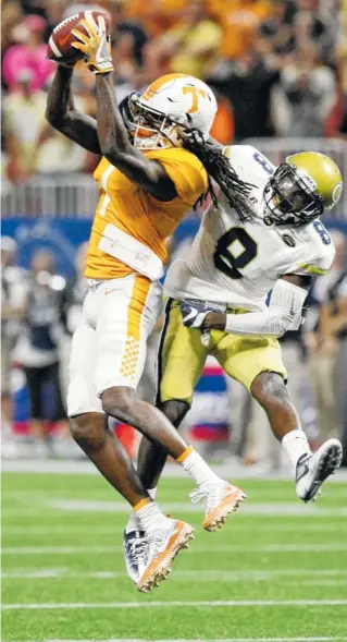  ?? STAFF PHOTO BY C.B. SCHMELTER ?? Tennessee wide receiver Marquez Callaway, left, pulls in a catch against Georgia Tech defender Step Durham during the Vols’ 42-41 double-overtime victory Monday at Mercedes-Benz Stadium in Atlanta.