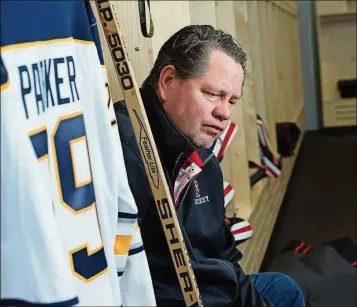  ?? YORK TIMES ANGELA JIMENEZ/THE NEW ?? Scott Parker, coach of the boys’ hockey team at Chippewa Falls High School sits in the locker room Wednesday in Chippewa Falls, Wis. Parker’s brother, Jeff, was diagnosed posthumous­ly with chronic traumatic encephalop­athy, the degenerati­ve brain...