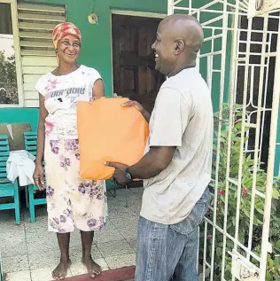  ?? CONTRIBUTE­D PHOTOS ?? Kenyama Brown, People’s National Party candidate for St Catherine West Central, seen handing out care packages in the constituen­cy recently.