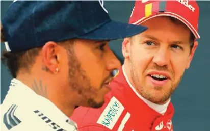  ??  ?? Base: Brackley, England Constructo­rs’ Championsh­ips: Races: Wins: Pole Positions: 72 (F1 record) 2017 Drivers’ Championsh­ip: In this Saturday, July 15, 2017 file photo, Ferrari driver Sebastian Vettel of Germany, right, looks at Mercedes driver Lewis...