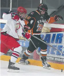  ?? DAN JANISSE ?? Tim Kaldeway, left, of the Petrolia Flyers tries to impede the progress of Essex 73’s Jack Sanko during action on Saturday.