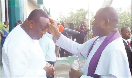  ??  ?? Governor Ifeanyi Ugwuanyi of Enugu State (left), being anointed by Rev. Fr. Anthony Njom, when “The Ifeanyi Ugwuanyi Prayer Organisati­on” paid the governor a solidarity visit at the Government House, Enugu... yesterday