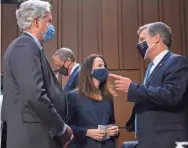  ?? POOL VIA AP ?? FBI Director Christophe­r Wray, right, speaks with CIA Director William Burns and Avril Haines, director of National Intelligen­ce before a Senate hearing Wednesday.
“China increasing­ly is a near-peer competitor challengin­g the United States in multiple arenas, while pushing to revise global norms.”