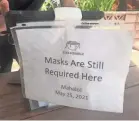  ??  ?? A sign at the host stand at Star Noodle in Lahaina, Hawaii, reminds guests of the indoor mask mandate.