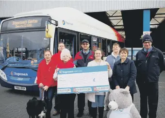  ??  ?? Stagecoach drivers have given a generous donation to St Benedict’s Hospice and Stray Aid.