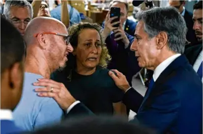  ?? JACQUELYN MARTIN/POOL/AFP VIA GETTY IMAGES ?? US Secretary of State Antony Blinken talked to people as he visited a donation center for victims of the weekend attack by Hamas, in Tel Aviv Thursday.