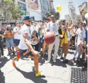  ?? Ezra Shaw, Getty Images ?? Golden State’s Stephen Curry kicks a basketball into the crowd during the Warriors’ victory parade Tuesday in Oakland, Calif.