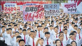  ?? REUTERS ?? An antius rally at Pyongyang's Kim Il Sung Square on Saturday. Placards read (LR) "A global military power", "Be through with the US", "The US is evil's headquarte­rs" and "Old foe the US".