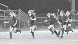  ?? KENNETH K. LAM ?? Sparrow Point players run to their goalie after defeating Towson on penalty kicks to win the Baltimore County girls soccer championsh­ip.