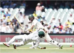  ??  ?? ADELAIDE: Australian batsman Jackson Bird (L) hits a ball past South African fielder Temba Bavuma during the third day of the third Test cricket match between Australia and South Africa at the Adelaide Oval in Adelaide yesterday. — AFP