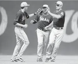  ?? MITCHELL LAYTON/GETTY IMAGES PHOTO ?? Christian Yelich, left, hit his sixth home run Saturday, and on Sunday had a double, stole two bases and sparked the winning rally with a leadoff walk in the eighth inning.