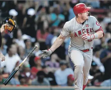  ?? Michael Dwyer Associated Press ?? MIKE TROUT tracks his 428-foot, two-run home run in the sixth inning over Fenway Park’s Green Monster in the Angels’ 12-4 victory over Boston. The outfielder has hit a home run in every American League ballpark.