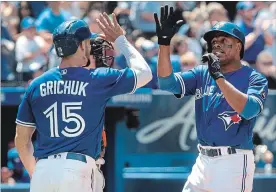  ?? FRED THORNHILL THE CANADIAN PRESS ?? Curtis Granderson, right, celebrates with Randal Grichuk after hitting a three-run home run against the Orioles’ in the fourth inning in Toronto Sunday afternoon.