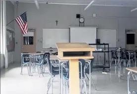  ?? DAVID GOLDMAN / AP ?? A classroom is seen vacant Friday through a window at Saint Raphael Academy in Pawtucket, R.I., as the school remains closed following a confirmed case of the coronaviru­s.