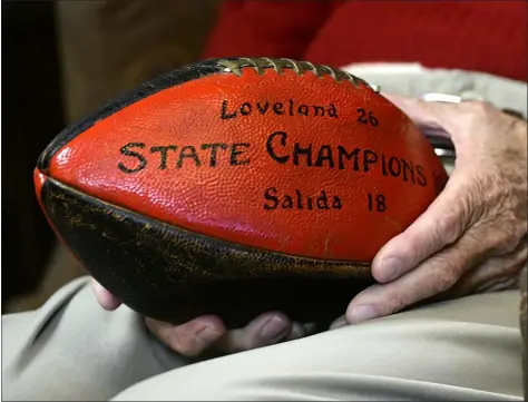  ?? JENNY SPARKS — LOVELAND REPORTER-HERALD ?? Ken Calkins holds the game football as he talks Thursday about being on the 1942 Loveland High School championsh­ip football team.