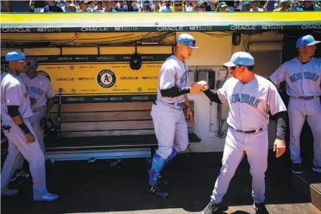  ?? Photos by Gabrielle Lurie / The Chronicle ?? Aaron Judge (center) and teammates get ready for Sunday’s game. The Yankees lost, and were swept in the four-game series.