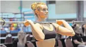  ?? GARY CURRERI/CORRESPOND­ENT ?? Davie’s Erica Stokes warms up before competing in the Olympics-style weightlift­ing challenge which was part of the Sunshine State Games sports showcase at the Palm Beach County Convention Center. Stokes placed second in the 69-kilogram division.