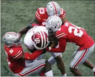  ?? JAY LAPRETE — THE ASSOCIATED PRESS ?? Ohio State defenders, left to right, Baron Browning, Marcus Hooker, and Shaun Wade tackle Indiana receiver Ty Fryfogle during the first half of Saturday’s game in Columbus, Ohio.