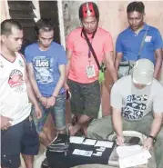  ?? CONTRIBUTE­D PHOTO ?? A police operative conducts inventory of the evidence seized from a suspected drug pusher after a buy-bust operation in Barangay Basak, Cebu City.