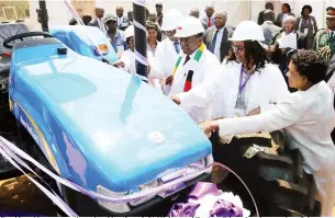  ?? ?? President Mnangagwa is assisted by (from left) Higher and Tertiary Education, Innovation, Science and Technology Developmen­t Minister Professor Amon Murwira, Vice chancellor Professor Doreen Moyo and the Minister of State for Matabelela­nd South Provincial Affairs and Devolution Evelyne Ndlovu to cut a ribbon during the handover of a tractor to the university yesterday