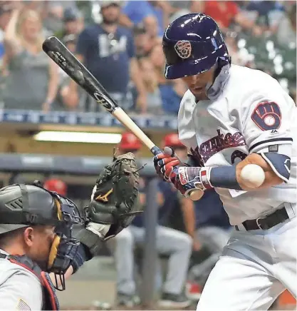  ?? ASSOCIATED PRESS ?? The Brewers' Nate Orf is hit by a pitch during the 10th inning against the Twins on Monday.