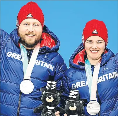 ?? Picture: Getty. ?? Silver medal winners Millie Knight and guide Brett Wild during the victory ceremony of the women’s super-G visually impaired alpine skiing at PyeongChan­g.