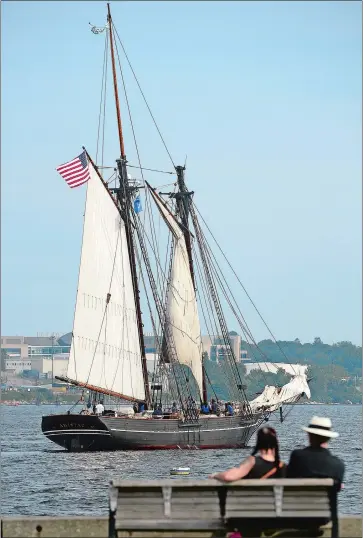  ?? SARAH GORDON/THE DAY ?? People watch from Custom House Pier as the Amistad returns to New London on Friday after the first of two two-week cruises with high school students who will be the first generation of their families to attend college. The schooner, run by Discoverin­g...