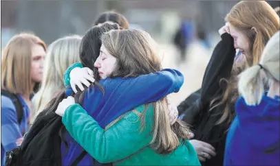  ?? Ryan Hermens The Paducah Sun ?? Students embrace following a prayer vigil Wednesday at Paducah Tilghman High School in Paducah, Ky.