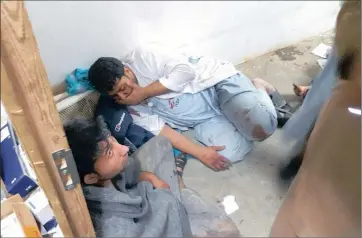  ?? PICTURE: DOCTORS WITHOUT BORDERS ?? SHOCK: Doctors Without Borders staff after a hospital in Kunduz, Afghanista­n, was bombed on Saturday. The writer says the global community should be more critical of “accidental” attacks on civilians.