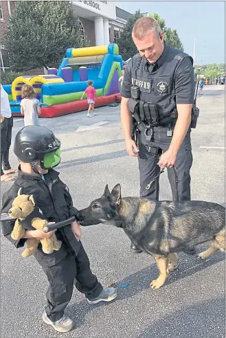  ?? GINGER RAE DUNBAR – MEDIANEWS GROUP ?? Hunter Mitchell, of West Chester, dressed up in his SWAT uniform to celebrate National Night Out. His favorite part of the event in West Chester was meeting K9 Mattie with the Chester County Sheriff’s Office.