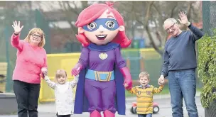  ??  ?? ●●Twins Poppy-Anne and George Dale taking their grandparen­ts and Rochelle the Healthy Hero for a toddle at the Heywood launch