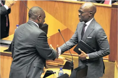  ??  ?? President Cyril Ramaphosa, left, shakes hands with Minister of Finance Malusi Gigaba after he delivered his Budget speech in Parliament earlier this week.