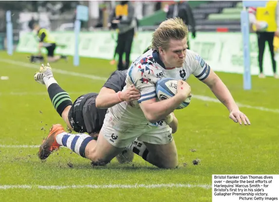  ??  ?? Bristol flanker Dan Thomas dives over – despite the best efforts of Harlequins’ Marcus Smith – for Bristol’s first try in his side’s Gallagher Premiershi­p victory.
Picture: Getty Images