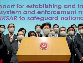  ?? AP ?? Hong Kong Chief Executive Carrie Lam, centre, and other officials attend a press conference in Hong Kong after returning from China’s National People’s Congress meeting in Beijing on Friday. Hong Kong’s pro-democracy lawmakers have criticised China’s move to enact national security legislatio­n in the semi-autonomous territory.