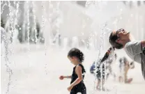  ?? PHOTO: REUTERS ?? Keeping cool . . . Tourists refresh themselves in a public fountain in Lisbon, Portugal, on Saturday.