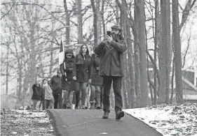  ?? MATT PARKER/SEACOASTON­LINE ?? Frank Staples, a founder of Absolute Defiance, leads a group of protesters and records the events during a march to Gov. Chris Sununu's home Sunday, Jan. 3, 2021 in Newfields.