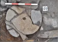  ??  ?? A broken rotary quern that formed part of the hearth slabs.