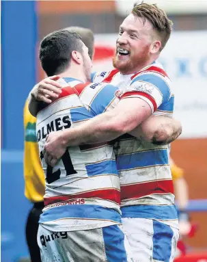  ??  ?? ●●Jack Holmes celebrates scoring with team mate Chris Riley