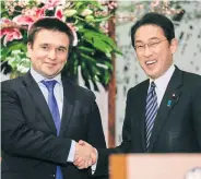  ?? EPA ?? Ukrainian Foreign Minister Pavlo Klimkin, left, and Japanese counterpar­t Fumio Kishida shake hands at the start of their talks at Iikura Annex of Foreign Ministry in Tokyo on Monday.