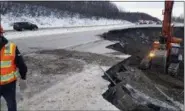  ?? CHRIS RIEKENA VIA AP ?? This photo provided by Chris Riekena shows excavation work being conducted Saturday near the Mirror Lake exit of the Glenn Highway near Eklutna, Alaska, to make the highway ready for repaving. The highway was heavily damaged in several spots following a magnitude 7.0 earthquake.