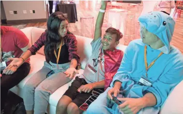  ??  ?? YouTube gamers enjoy a little friendly video game competitio­n with St. Jude patients during a gaming event at St. Jude Children's Research Hospital on Aug. 17.