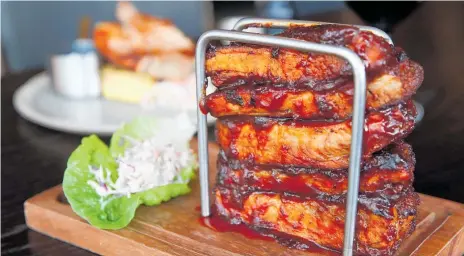  ?? PHOTO / GETTY IMAGES ?? Ribs in a toast rack at Dirty Laundry.