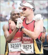  ?? PICTURE: MOTSHWARI MOFOKENG/AFRICAN NEWS AGENCY(ANA) ?? Daniel Nendouvhad­a and Stu Rawlinson, both of the Wanderers Athletic Club embrace after finishing the race.