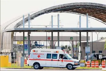  ?? Miguel Roberts / Associated Press ?? A Mexican Red Cross ambulance transports two Americans found alive after their abduction in Mexico last week to a Brownsvill­e Fire Department EMS ambulance through Veterans Internatio­nal Bridge at Los Tomates in Brownsvill­e, Texas, Tuesday.