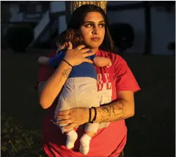  ?? RACHEL BUJALSKI — THE NEW YORK TIMES ?? Arabella Guevara with her baby Joshias outside her apartment in San Jose in 2022. Guevara is one of thousands of teenagers and young adults across the country paying restitutio­n imposed by juvenile courts.