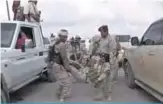  ??  ?? An image grab taken from a video obtained by AFPTV shows a wounded Yemeni soldier being carried by comrades after a drone exploded above Yemen’s al-Anad airbase in the government-held southern province of Lahj. —AFP