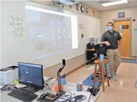 ?? GARY COSBY JR./USA TODAY NETWORK ?? Clancy Bryant, an English teacher in Tuscaloosa, Ala., teaches both in-person students and remote students who see him through the camera.