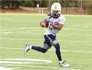  ?? STAFF PHOTO BY TIM BARBER ?? UTC running back Richardre Bagley makes a catch during drills at the Mocs’ second practice this spring. Bagley is by far the most experience­d player at his position as the Mocs prepare for their first season under new coach Tom Arth.